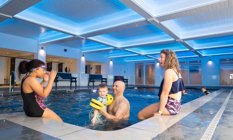 Family playing in Indoor Swimming Pool at Woolacombe Sands Holiday Park in Devon